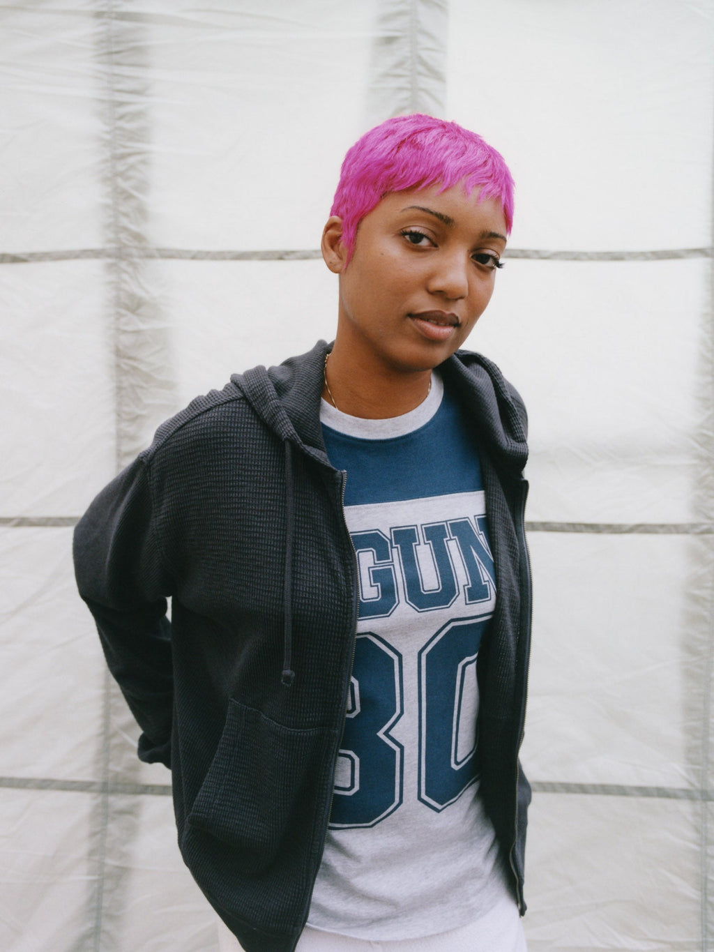 Model wearing Lightweight Thermal Hoodie in Faded Black over the Laguna 80 Jersey in Blue against a textured grid background.