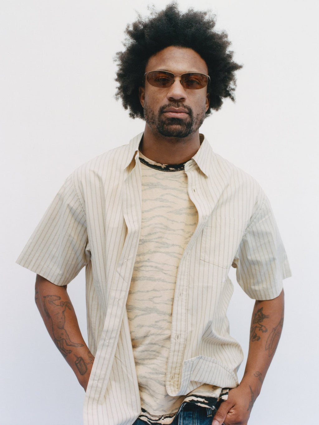 Model wearing Standard SS Shirt in Yellow Stripe over a patterned t-shirt against a white background.