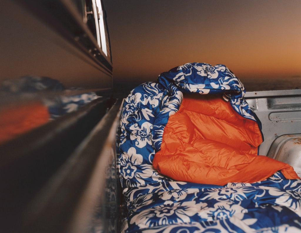Stüssy & Mountain Hardwear Bishop Pass 30F Sleeping Bag in the back of a vehicle at sunset.